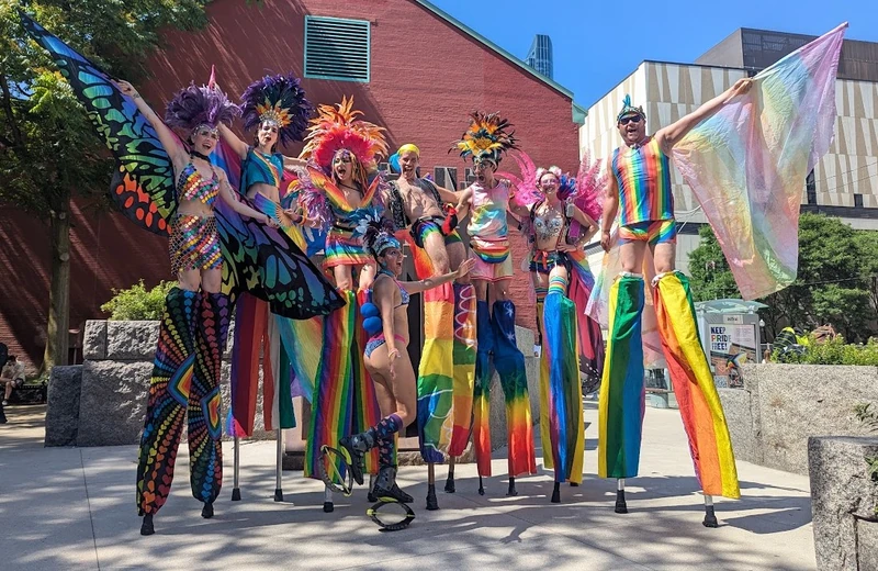 Pride stilt performers at outdoor event